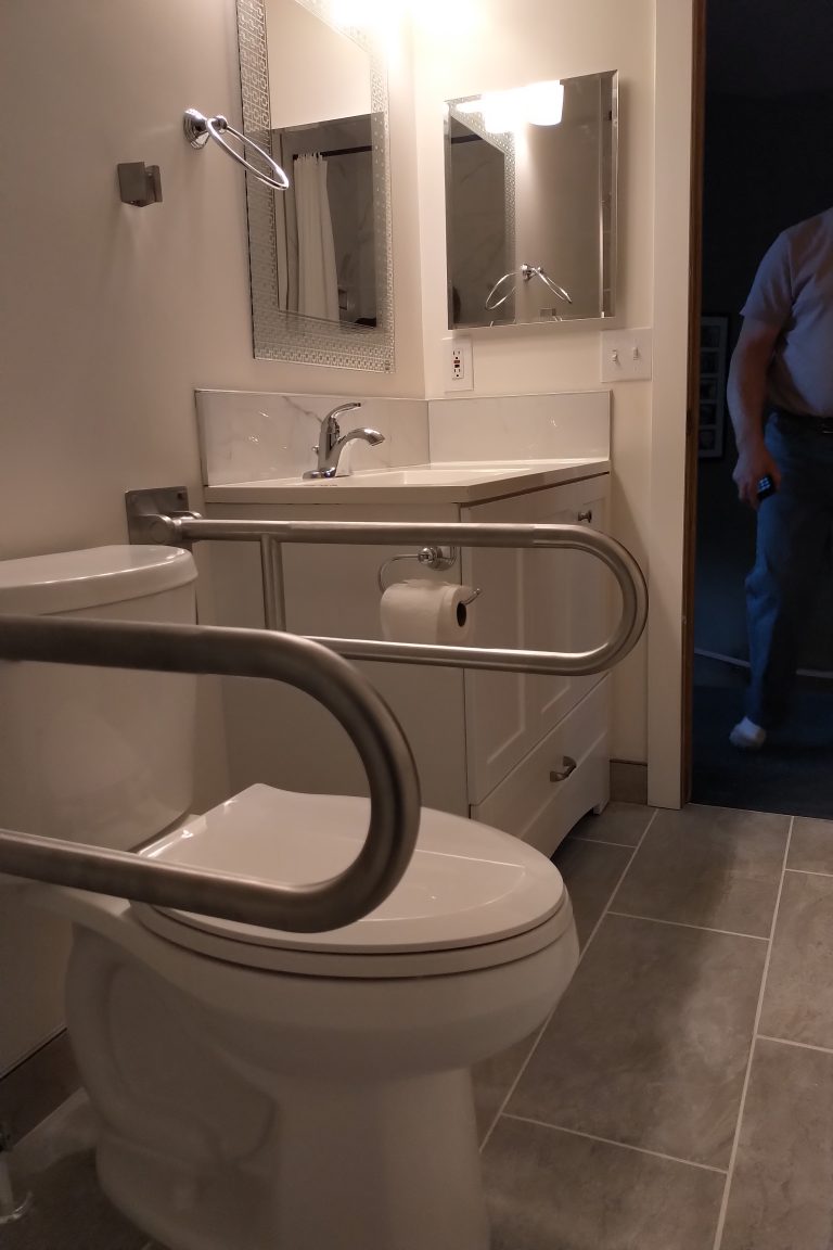 Toilet with folding grab bars