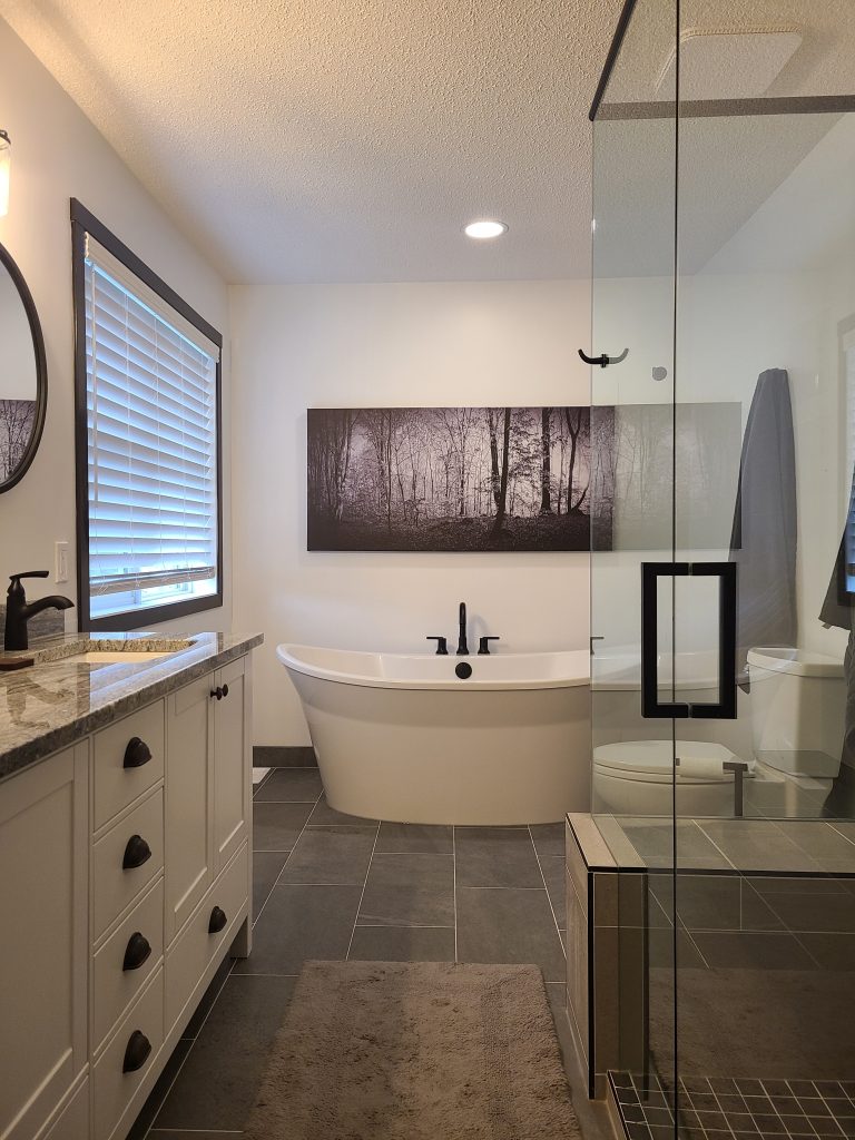 Freestanding tub glass shower and double vanity after renovation